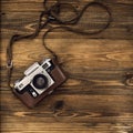 Old retro camera on vintage rustic wooden planks boards. Education photography courses back to school concept abstract background Royalty Free Stock Photo