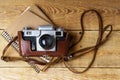 Old retro camera on vintage rustic wooden planks boards. Royalty Free Stock Photo