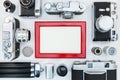 Old retro cameras, roll films, tripod and red photo frame. old m Royalty Free Stock Photo