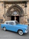 Old retro car in front of the University of Glasgow