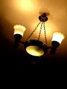 Old retro chandelier on the ceiling yellow warm light Royalty Free Stock Photo
