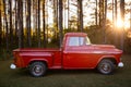 An old retro classic red American pickup truck parked outside in the country Royalty Free Stock Photo