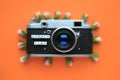 Old Retro film photo camera and the words Summer time, and flowers, on an orange background. Summer concept. Royalty Free Stock Photo