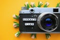 Old Retro film photo camera and the words Summer time, and flowers, on a yellow background. Summer concept. Royalty Free Stock Photo