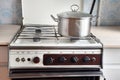 Old retro gas stove with pans and kettle. photo of obsolete kitchen utensils. Royalty Free Stock Photo