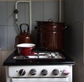 Old retro gas stove with pans and kettle. photo of obsolete kitchen utensils Royalty Free Stock Photo