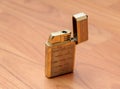 Old retro golden lighter closeup on vintage boards Royalty Free Stock Photo