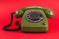 Old retro green phone on red background Royalty Free Stock Photo