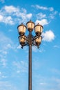 The old retro lamp post and the beautiful white and blue sky Royalty Free Stock Photo