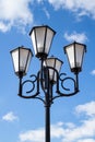 The old retro lamp post and the beautiful white and blue sky Royalty Free Stock Photo