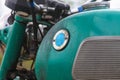 The old retro motorcycle - partial view of dirty tank with smudges of gasoline and handlebar