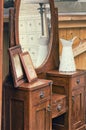 Old retro objects antique dressing table with mirror, framed photographs and jug