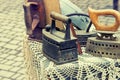 Old retro objects antique iron irons on a table, vintage image retro style. Royalty Free Stock Photo