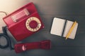 old retro phone with contact notebook on wooden table. top view Royalty Free Stock Photo