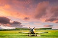 Old Retro Plane Aircraft Aeroplane, Airplane Biplane Parked In Grass Airfield. Altered Sunset Sunrise Sky Royalty Free Stock Photo