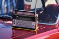 Old retro radio with antenna on a vintage retro car hood