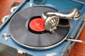 An old retro record playing on old vintage gramophone at flea market. Royalty Free Stock Photo