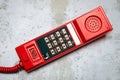 Old, retro red push-button telephone on the background of a plastered wall Royalty Free Stock Photo