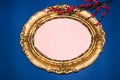 old retro royal frame and pastel pink copy space, around it a dark blue background with a sprig of flowers