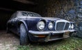 Old retro rusty car in village garage