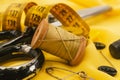 Old retro sewing accessories lie on a yellow fabric. Needle and thread Royalty Free Stock Photo
