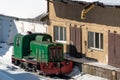 old retro shunting diesel locomotive at the repair station. Snow-covered railway station and tracks. Winter landscape. Open-air
