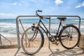 Old retro style bike parked on a sandy beach on a backgrouns of blue sea Royalty Free Stock Photo