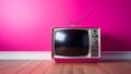 Old retro TV, vintage 60s television in pink color on wood floor Royalty Free Stock Photo