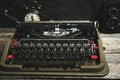 Old retro typewriter, alarm clock and camera on a wooden background