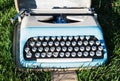 Old retro typewriter on the grass