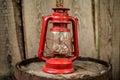 Old retro vinatge style decoration item red kerosene oil lamp on wooden wall background Royalty Free Stock Photo