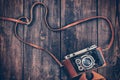 Old retro vintage camera on grunge wooden background Royalty Free Stock Photo