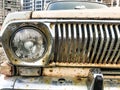 An old retro vintage hipster rusty oxidized chrome-plated metallic silver radiator grille and a round glass retro spotlight Royalty Free Stock Photo