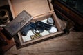 Old vintage revolver gun with ammunitions in wooden box for letters