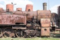 Old retro vintage rusty locomotive standing on rails, on the background of blue sky Royalty Free Stock Photo