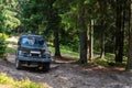 Old retro vintage 4x4 SUV on a dirt gravel dirt road in summer. Off-road car mountain safari adventure nature trip Royalty Free Stock Photo