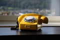 Old Retro Vintage Yellow Rotary Phone on black wood table Royalty Free Stock Photo