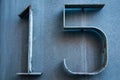 Old retro weathered metal stainless steel cold blue plate with the number 15