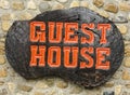 Old retro wood sign with the text Guest house.