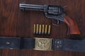 Old revolver with cartridges and U.S. Army soldier& x27;s belt with a buckle