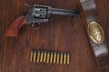 Old revolver with cartridges and U.S. Army soldier& x27;s belt with a buckle