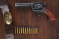 Old revolver with cartridges and U.S. Army soldier& x27;s belt with a buckle