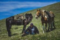 Old rider walk two horses on the mountainside