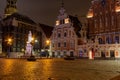 Old Riga the capital of Latvia at night. House of Blackheads in the Town Hall Square and the spire of the Cathedral in the Royalty Free Stock Photo