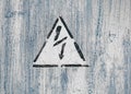 Old risk of electric shock triangle sign on light grey weathered cracked background Royalty Free Stock Photo