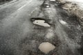 Old road. Concept highway in huge pits and potholes cloudy wea