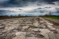Old road potholes holes outside city autumn weather HDR Royalty Free Stock Photo