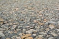 The old road, small stones and asphalt close up with a small depth of field.
