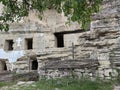 Old rock monastery. Empty window openings. Wooden cross. Royalty Free Stock Photo