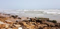 old rocks in front of sea waves and sky